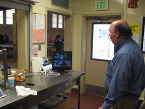 photo of chief cook Glen Jr. K6GNG watching ATV transmission of speaker